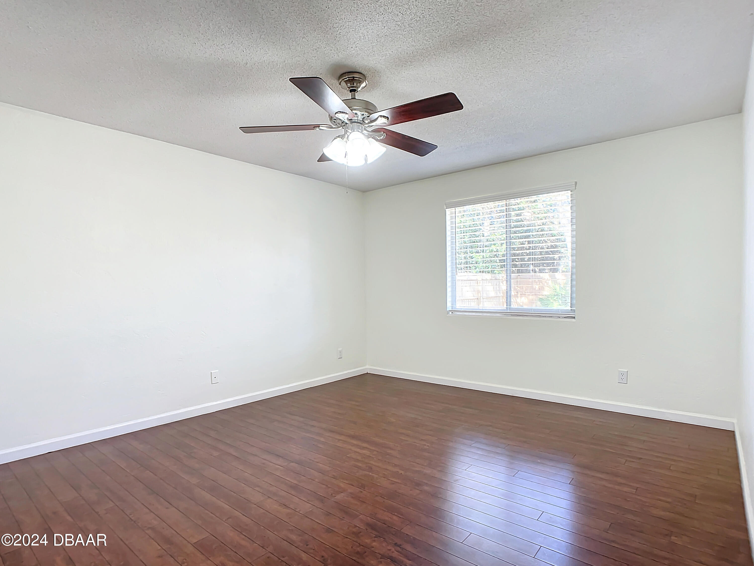 55 Merrywood Circle Ormond Beach, FL 32174 - Photo 39 of 64 an empty room with wooden floor fan and windows