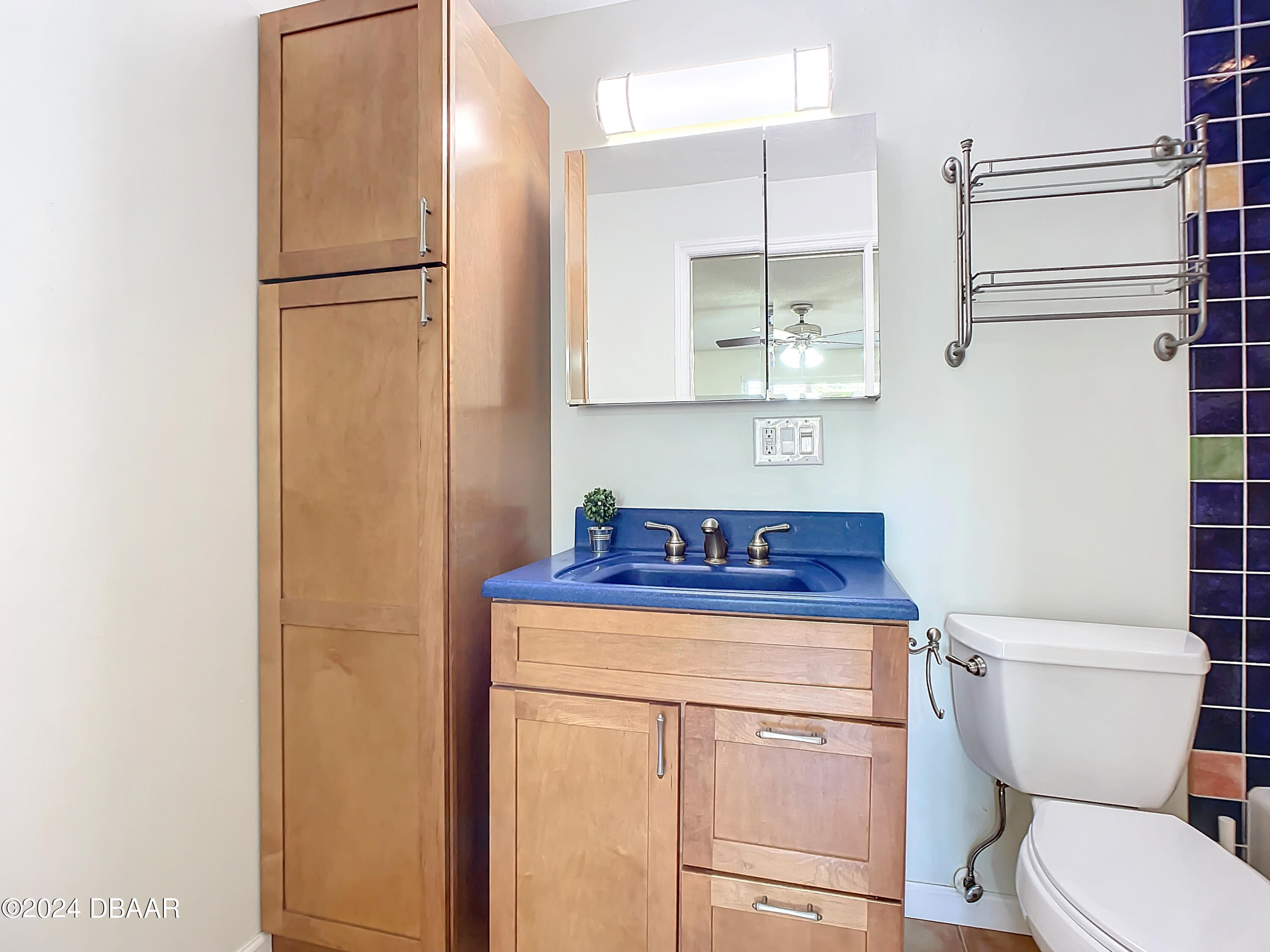 55 Merrywood Circle Ormond Beach, FL 32174 - Photo 41 of 64 a bathroom with a toilet a sink and a refrigerator