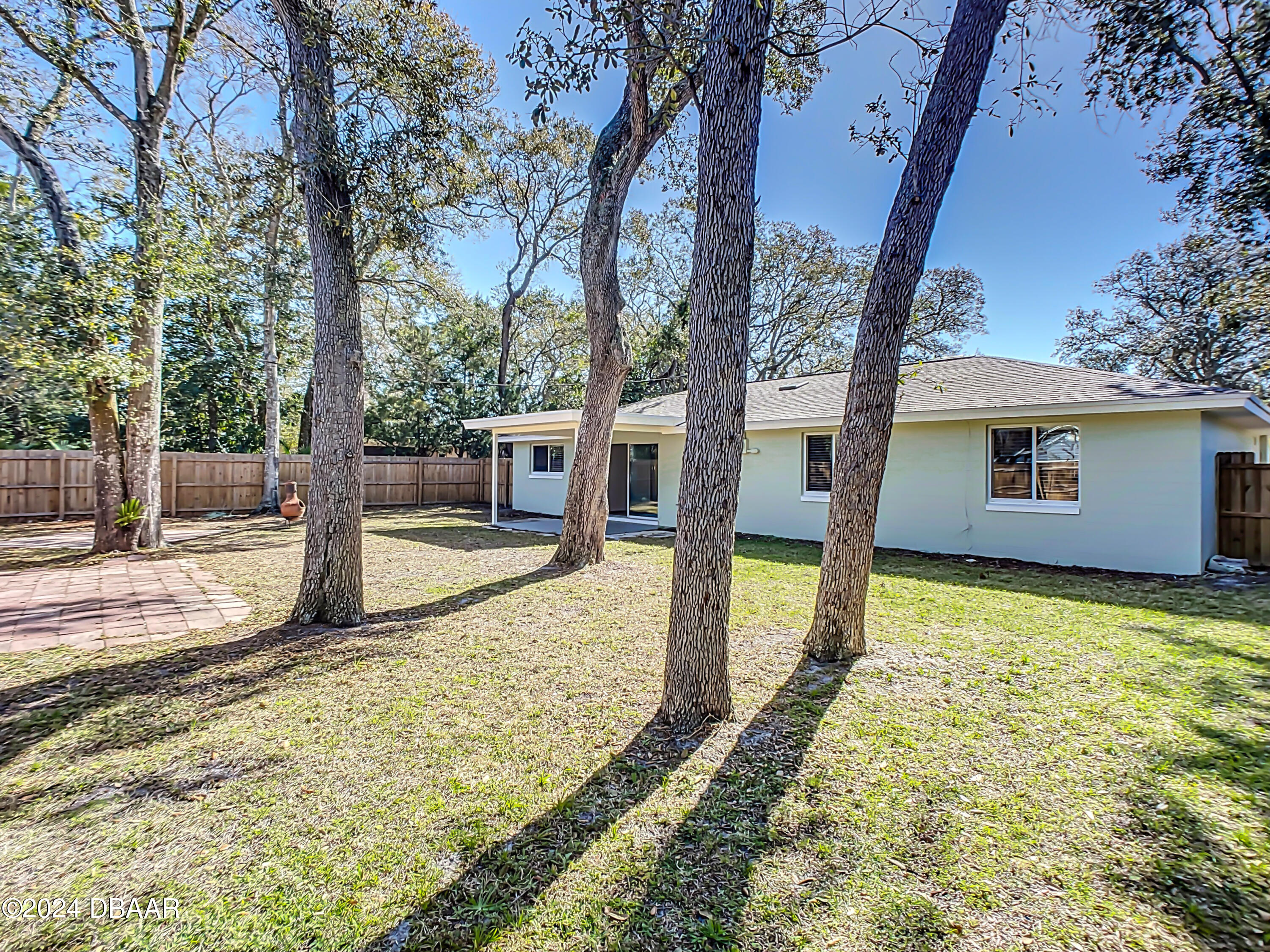 55 Merrywood Circle Ormond Beach, FL 32174 - Photo 50 of 64 a view of a house with backyard and trees