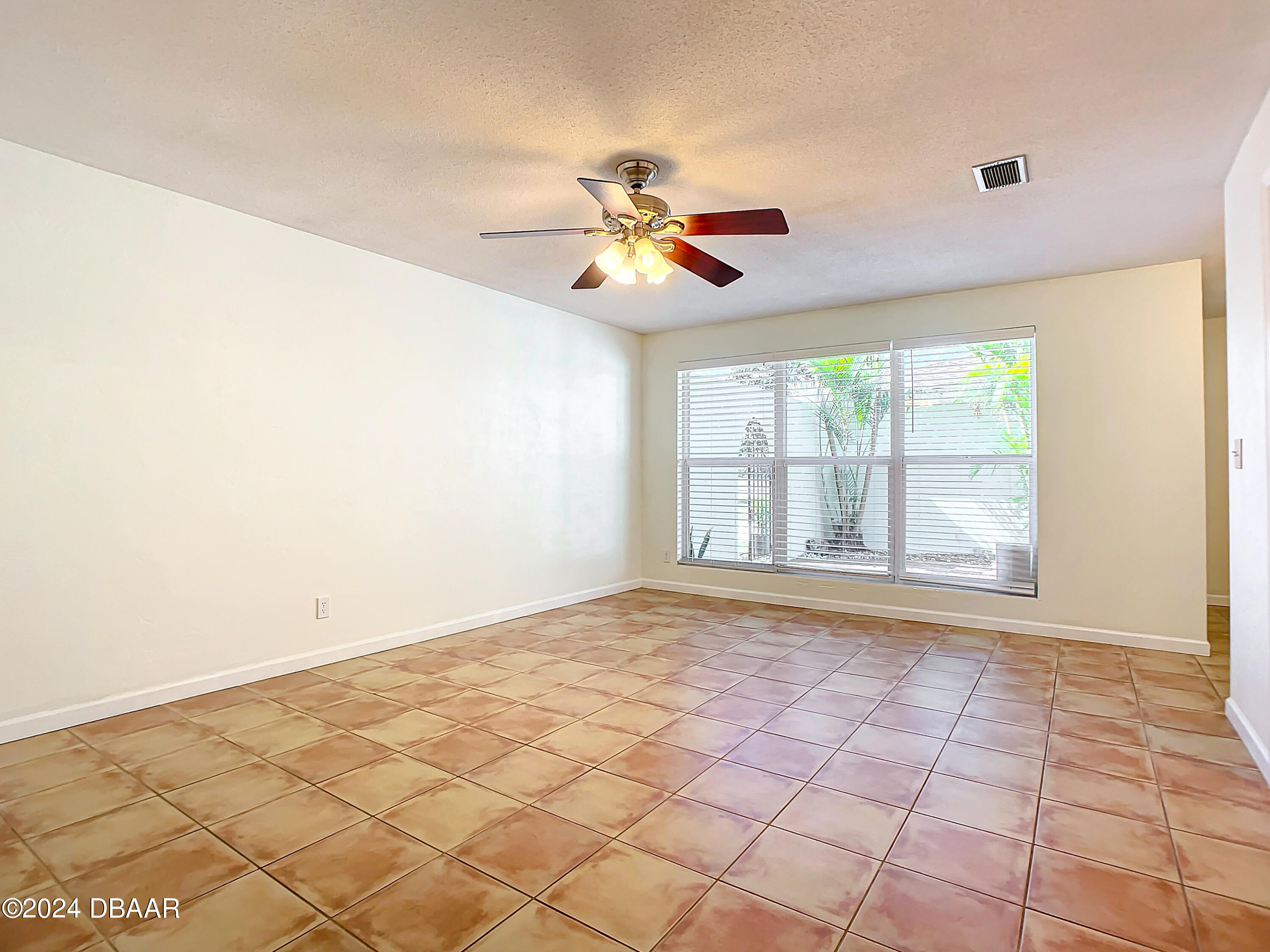 55 Merrywood Circle Ormond Beach, FL 32174 - Photo 8 of 64 a view of empty room with wooden floor and fan