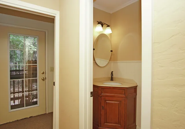 a bathroom with a sink a mirror and a window