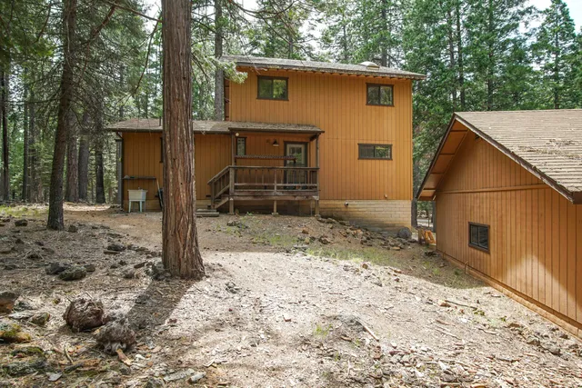 a view of a house with a yard and garage