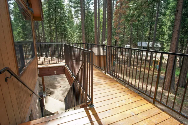 a view of balcony with wooden floor and fence