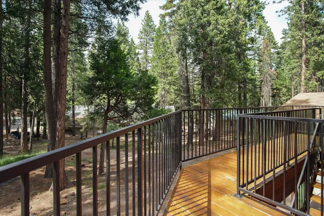 a view of balcony with deck and trees