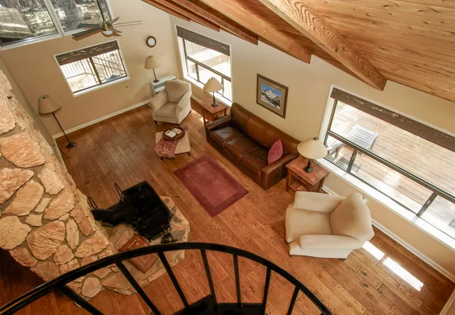 a view of a living room and dining room with wooden floor