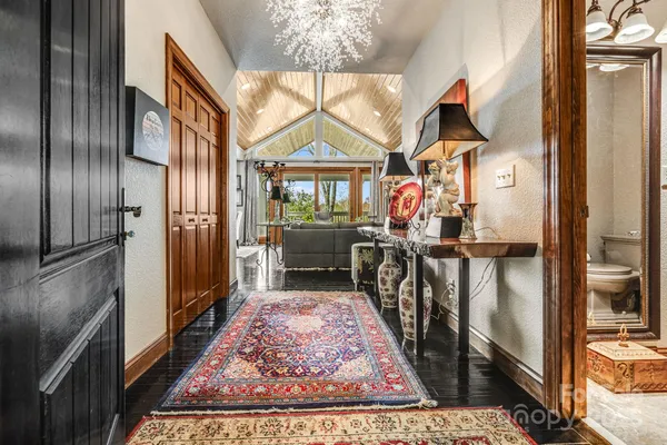 a living room with furniture a flat screen tv and a large window