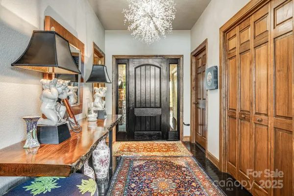 a dining room filled chandelier and wooden floor