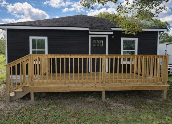 a view of a house with wooden fence