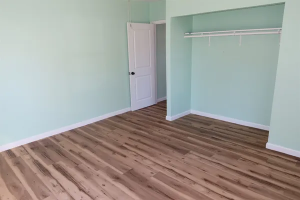a view of a room with wooden floor