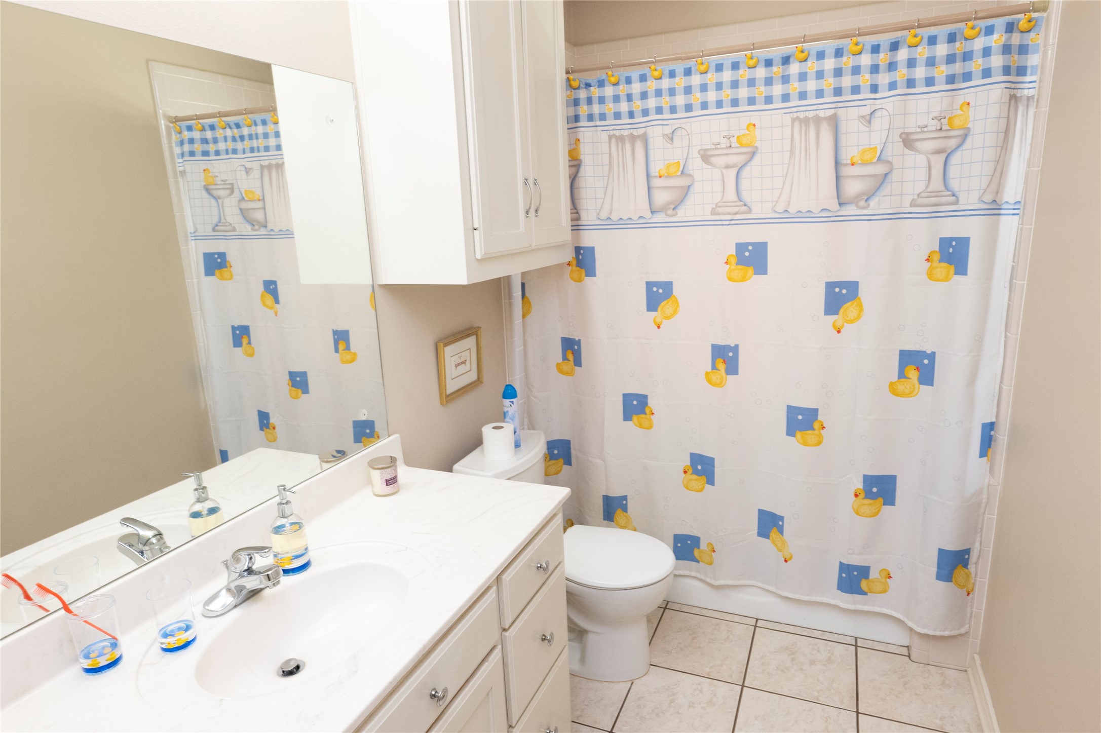 1608 Allison Street Brenham, TX 77833 - Photo 12 of 16 a bathroom with a sink a toilet and shower curtain