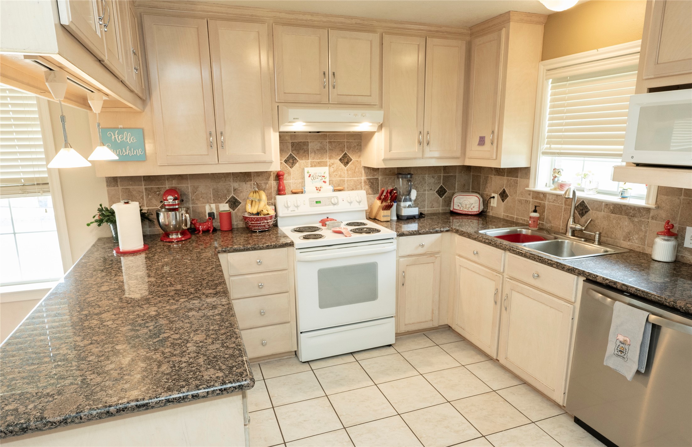 1608 Allison Street Brenham, TX 77833 - Photo 7 of 16 a kitchen with white cabinets and white appliances
