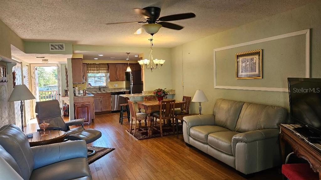 4600 98th Way North, Unit 210 St. Petersburg, FL 33708 - Photo 10 of 33 a living room with furniture and a flat screen tv