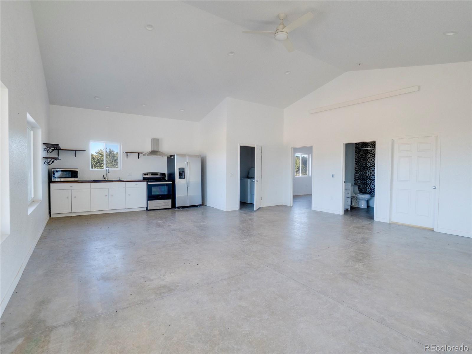491 Ketchum Road Walsenburg, CO 81089 - Photo 16 of 20 a view of a furniture and an empty room with a kitchen