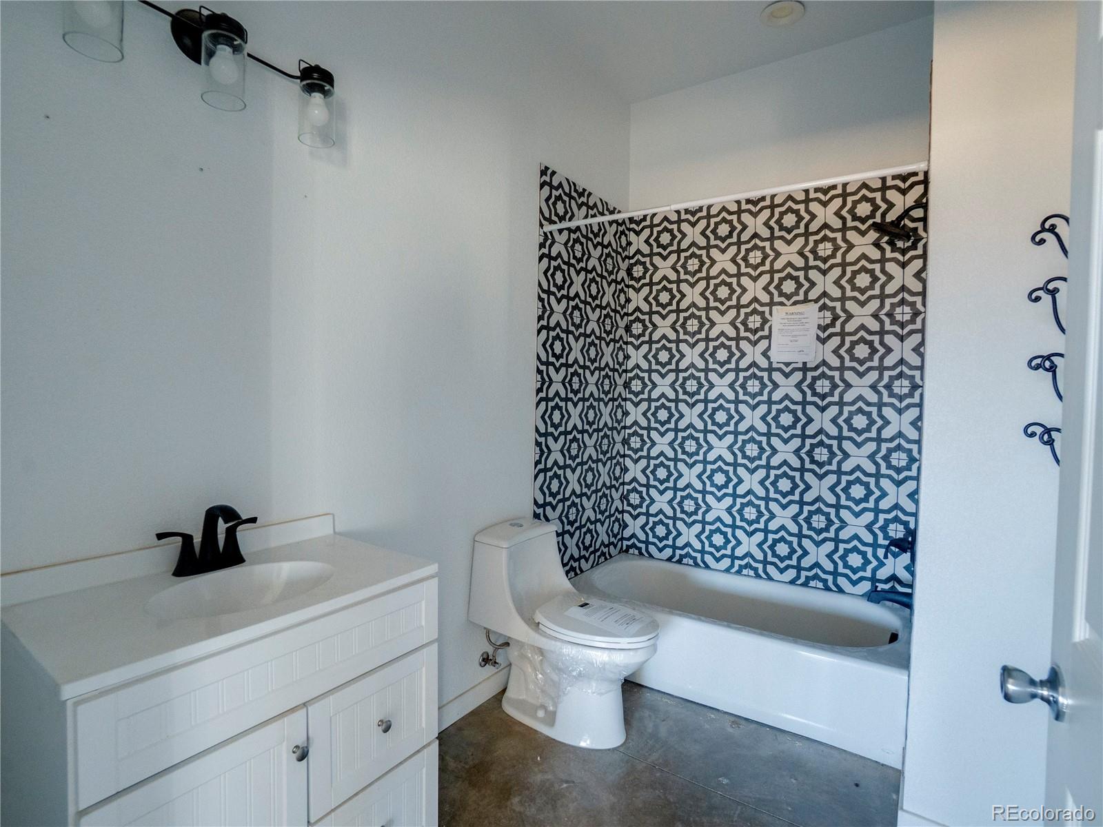491 Ketchum Road Walsenburg, CO 81089 - Photo 8 of 20 a bathroom with a toilet and a shower curtain