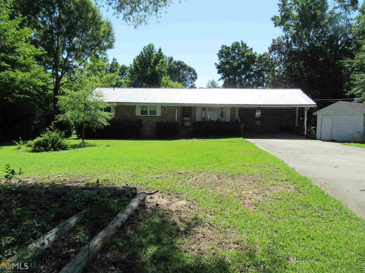 10641 Flat Shoals Road Covington, GA 30016 - Photo 1 of 1 a view of a backyard with floor to ceiling window and tree