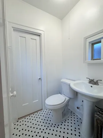 a bathroom with a sink a toilet and a mirror
