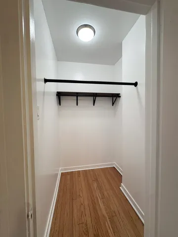 a view of a room with wooden floor