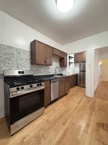 a kitchen with stainless steel appliances granite countertop a stove top oven and sink