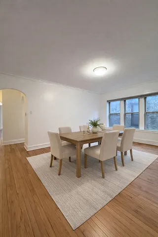 a view of a dining room with furniture and wooden floor