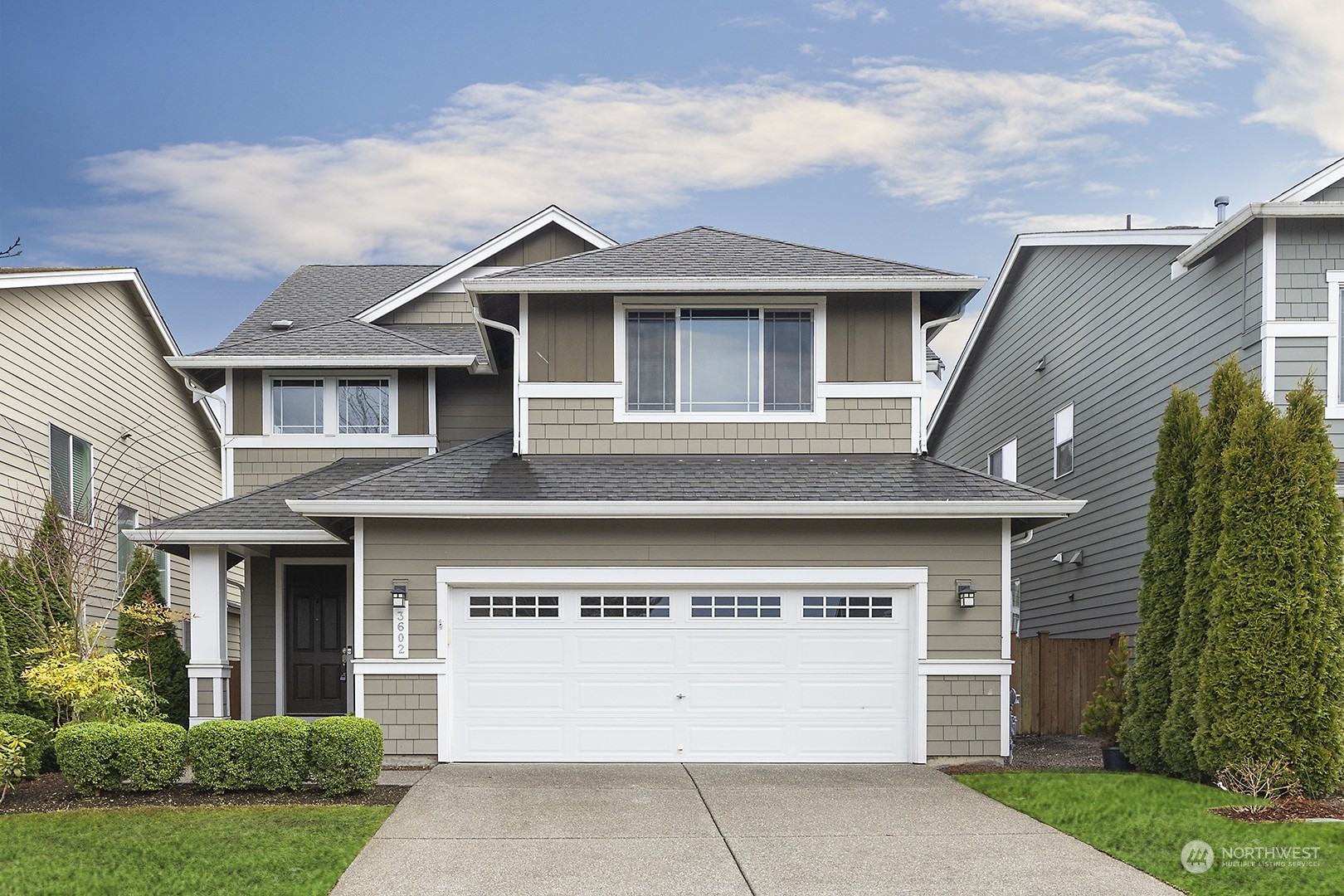 3602 195th Place Southeast Bothell, WA 98012 - Photo 1 of 28 a front view of a house with a yard and garage
