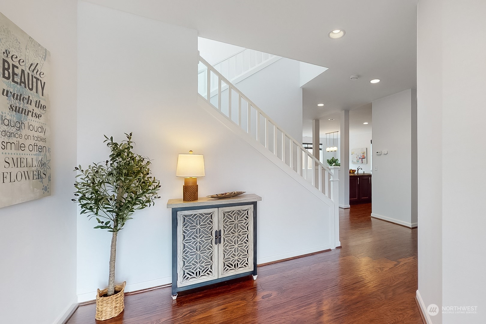 3602 195th Place Southeast Bothell, WA 98012 - Photo 2 of 28 a view of a hallway with wooden floor and a potted plant