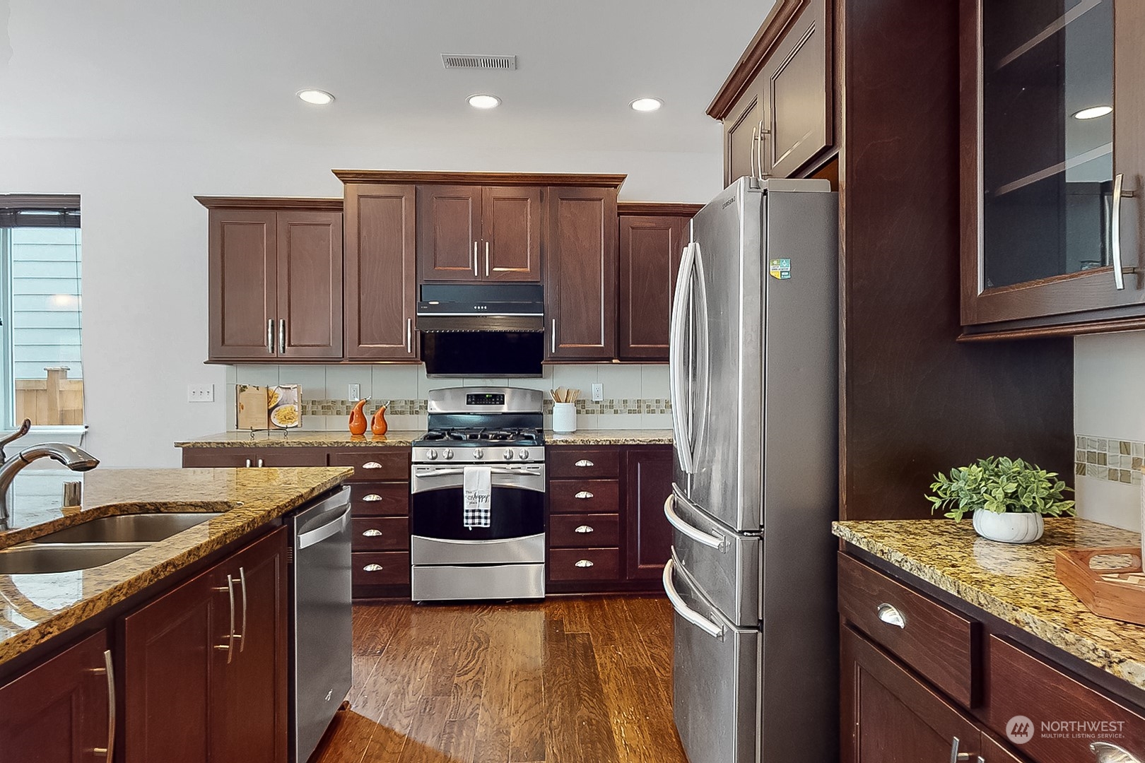 3602 195th Place Southeast Bothell, WA 98012 - Photo 7 of 28 a kitchen with stainless steel appliances granite countertop a refrigerator stove and sink