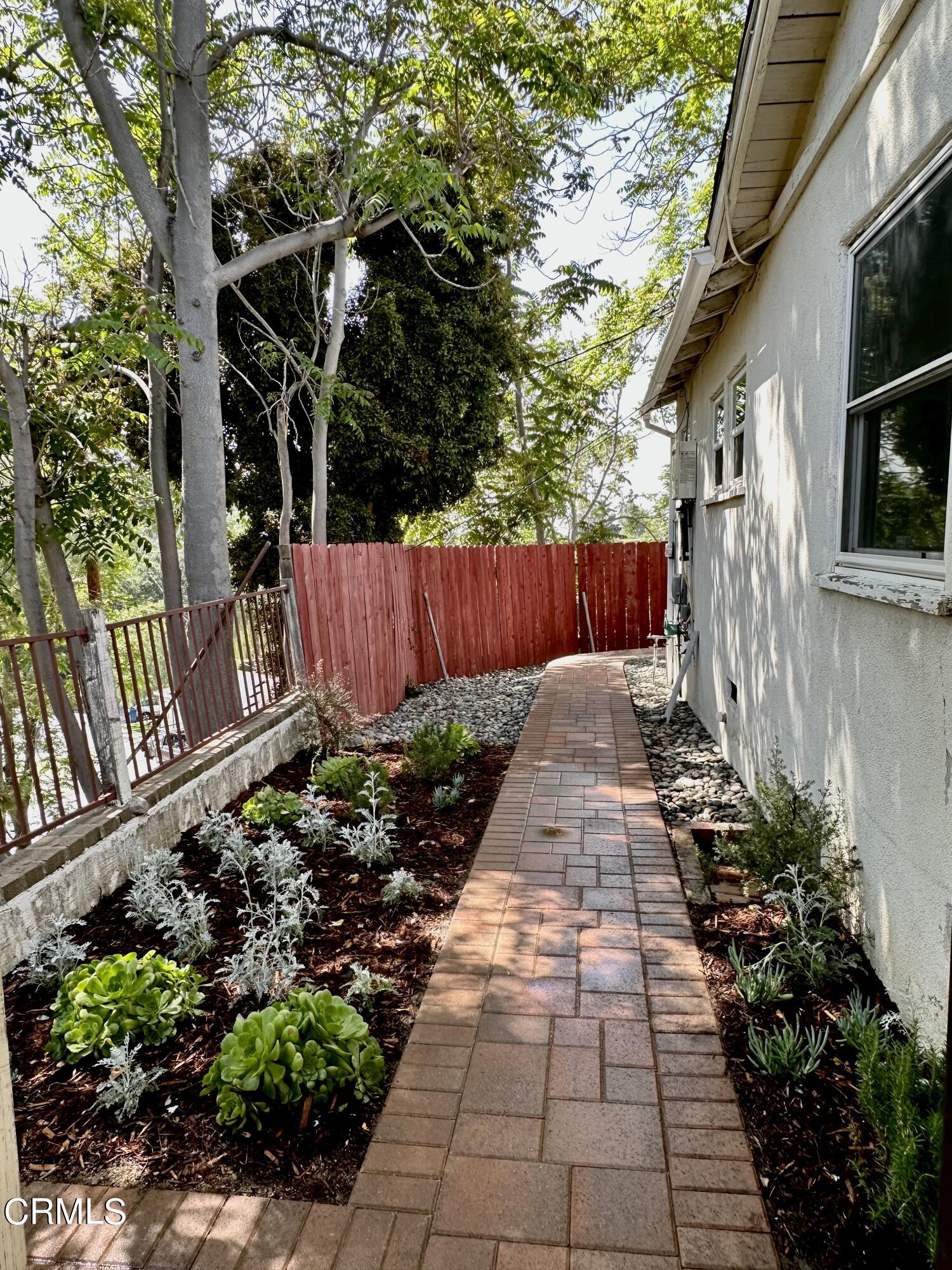 9817 Commerce Avenue Tujunga, CA 91042 - Photo 3 of 7 a view of a pathway with a flower garden