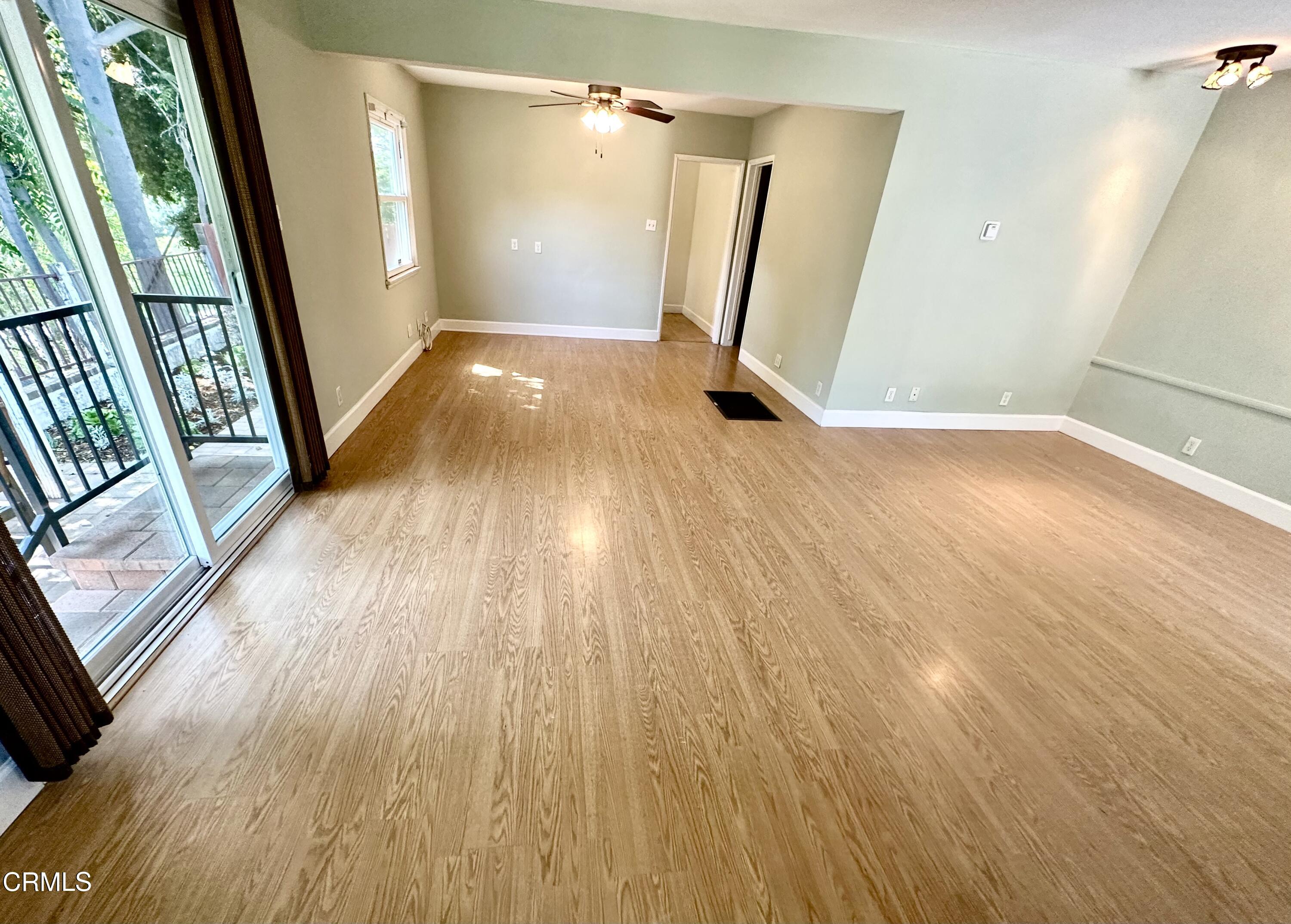 9817 Commerce Avenue Tujunga, CA 91042 - Photo 5 of 7 a view of an empty room with wooden floor and a window