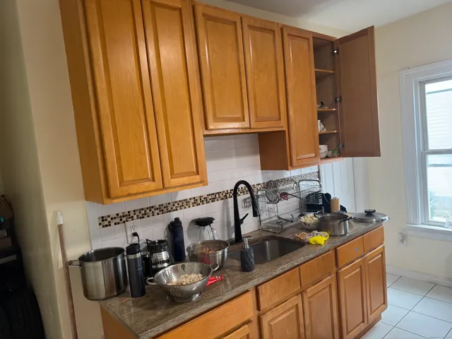 a kitchen with a sink and cabinets