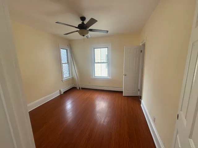 wooden floor in an empty room with a window