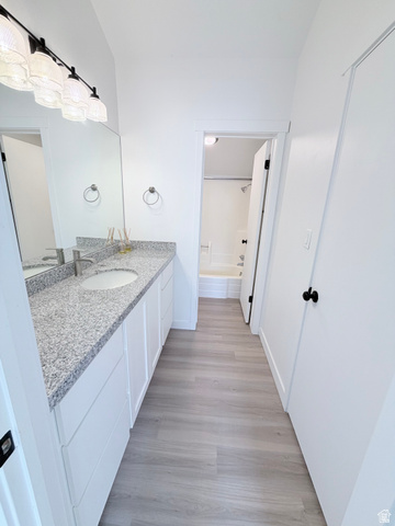 227 South West Lane Provo, UT 84601 - Photo 10 of 25 Bathroom featuring an extended vanity with a light-colored speckled countertop, undermount sink, and modern black hardware
