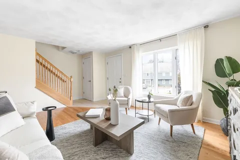 a living room with furniture and a potted plant