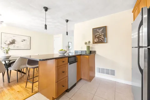 a kitchen with stainless steel appliances granite countertop a refrigerator and a sink