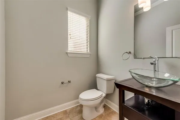 a bathroom with a toilet a sink and a window