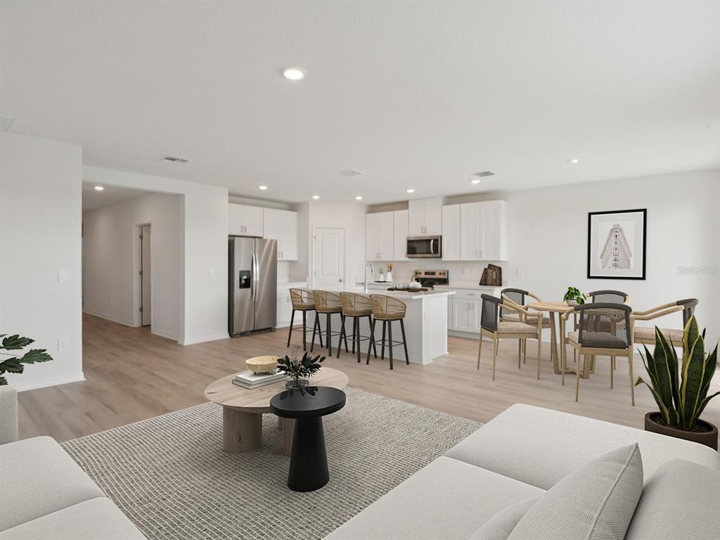 1655 Bark Rdg Drive Auburndale, FL 33823 - Photo 4 of 21 a living room with furniture a view of kitchen and a potted plant