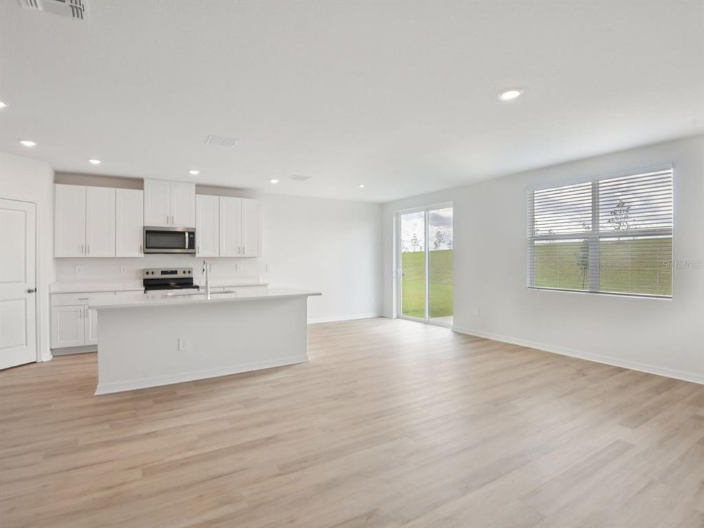 1655 Bark Rdg Drive Auburndale, FL 33823 - Photo 5 of 21 a view of kitchen with wooden floor and windows