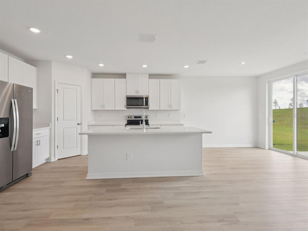 1655 Bark Rdg Drive Auburndale, FL 33823 - Photo 8 of 21 a view of kitchen with stainless steel appliances refrigerator sink and cabinets
