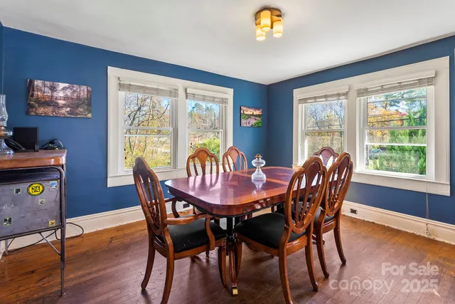 a dining room with furniture a window and wooden floor