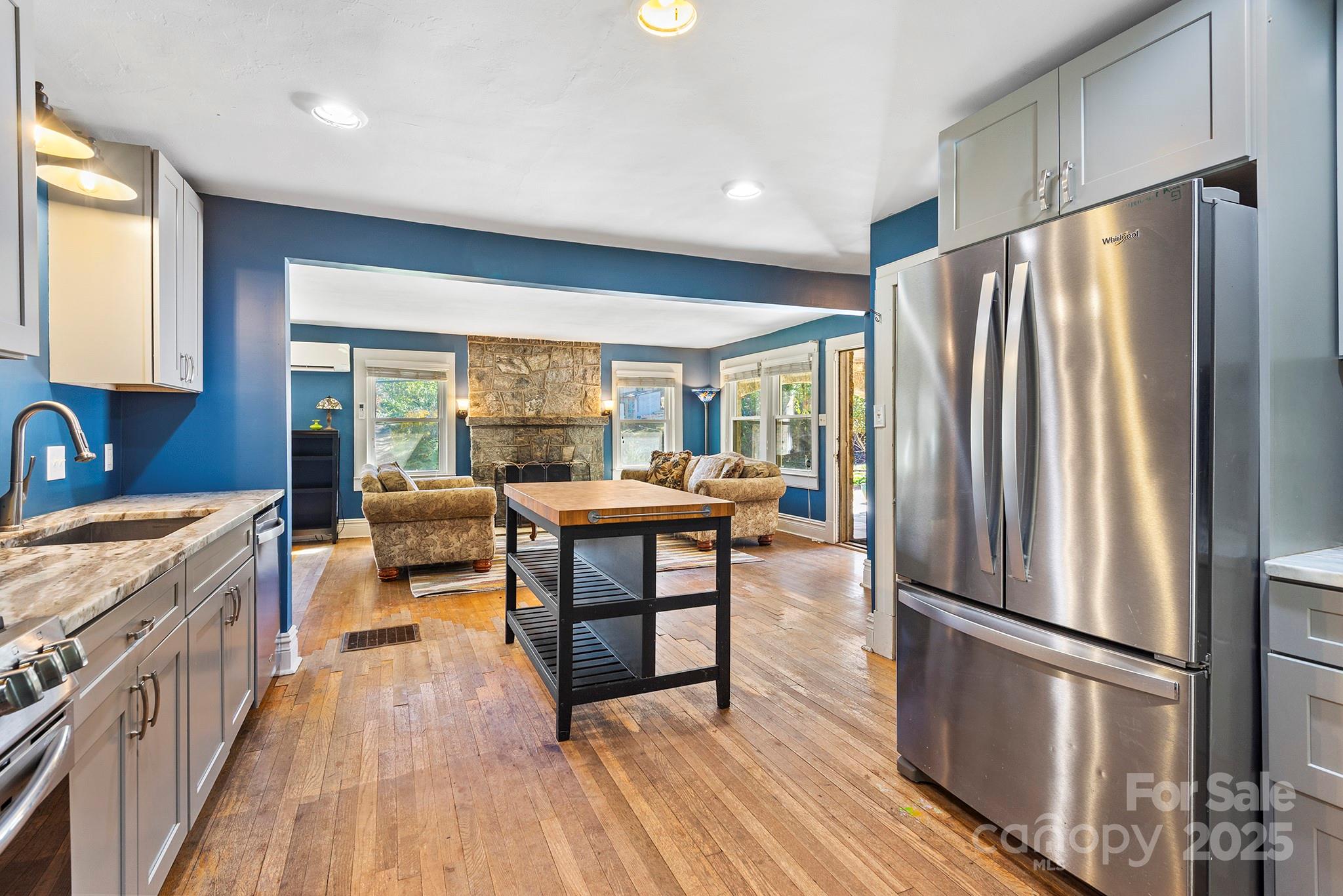 914 Catheys Creek Church Road Brevard, NC 28712 - Photo 18 of 33 a kitchen with sink a refrigerator and wooden floor