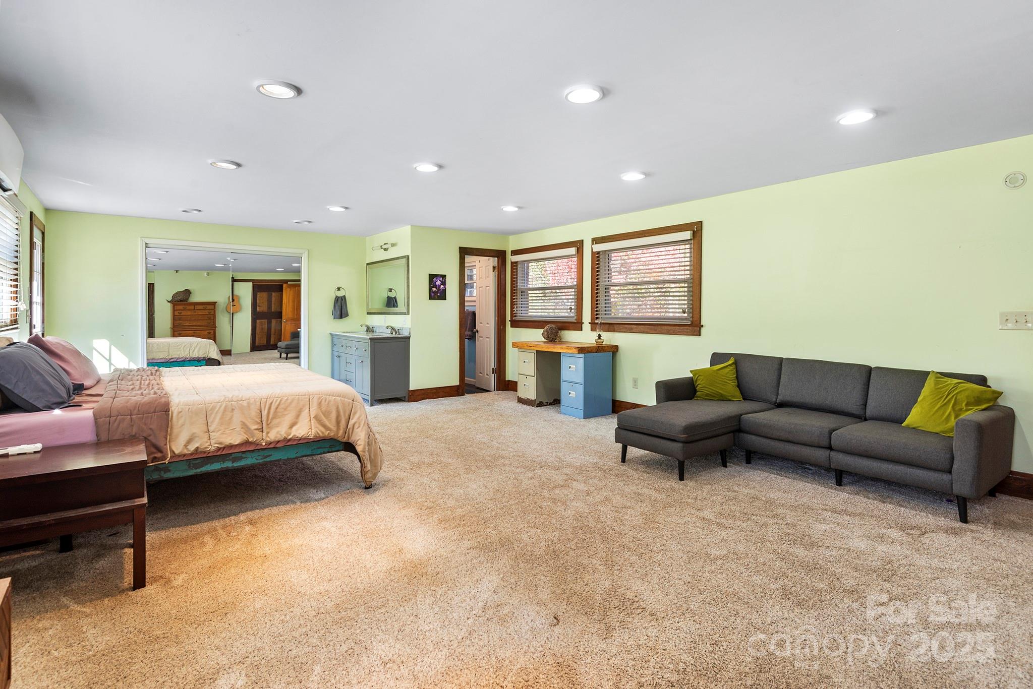 914 Catheys Creek Church Road Brevard, NC 28712 - Photo 22 of 33 a spacious bedroom with a bed a couch and dresser