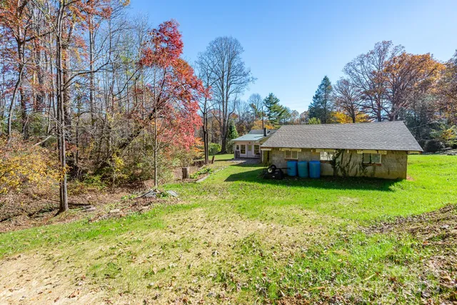 a view of a house with a yard and sitting area