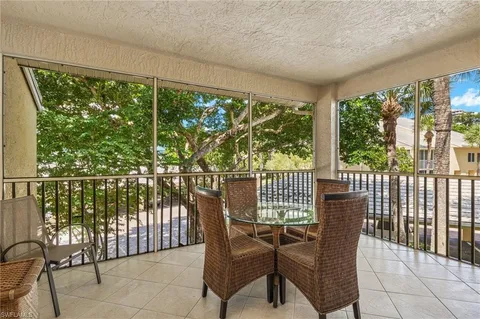 a view of a chairs and table in the balcony