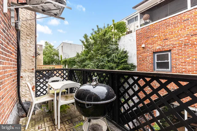 a balcony with table and chairs