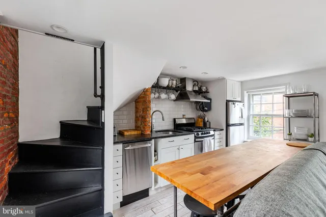 a kitchen with sink cabinets and stove top oven