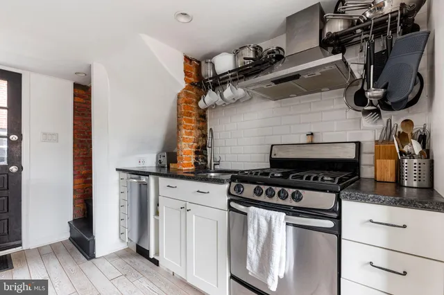 a kitchen with appliances cabinets and a stove top oven