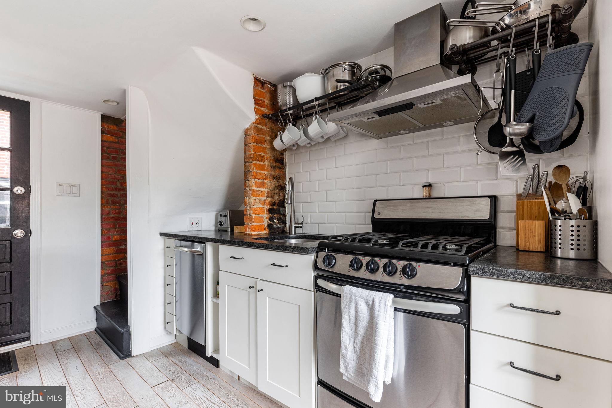 2127 Rodman Street Philadelphia, PA 19146 - Photo 10 of 19 a kitchen with appliances cabinets and a stove top oven