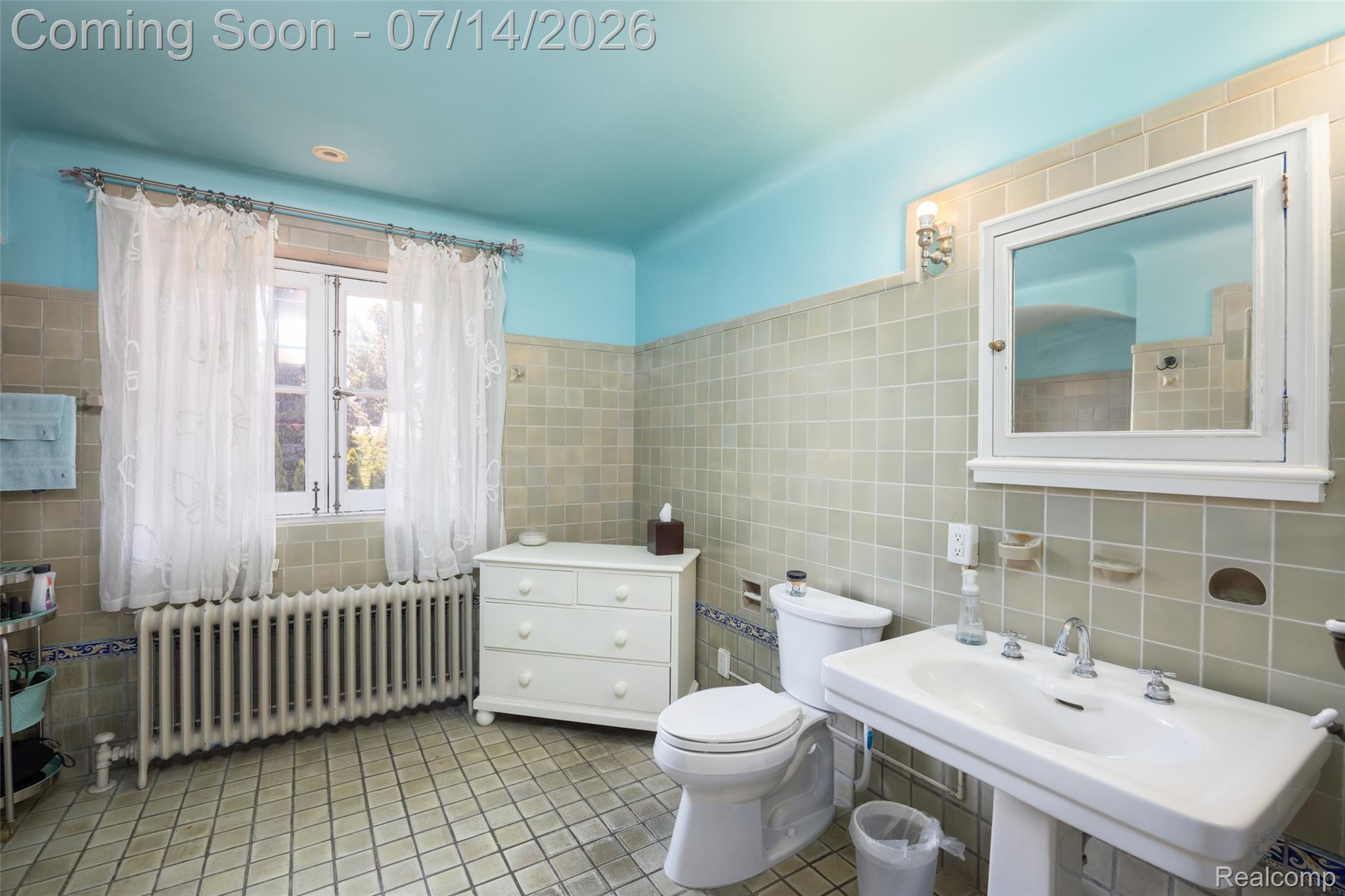 189 Cloverly Road Grosse Pointe, MI 48236 - Photo 48 of 96 Bathroom featuring floor-to-ceiling square tiling, a pedestal sink with dual faucets, a wall-mounted medicine cabinet with mirror, and a window with white trim