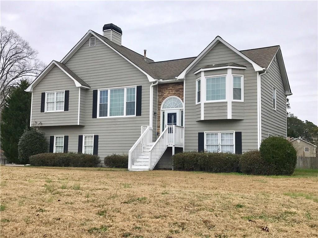 a front view of a house with a yard