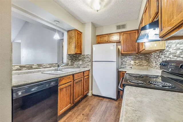 a kitchen with a refrigerator and a stove