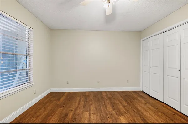 a view of a room with wooden floor and brick walls